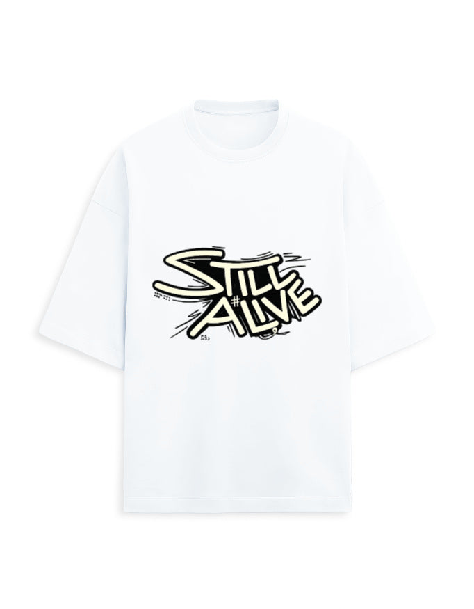 White oversized terry tee with bold 'Still Alive' graffiti-style typography chest print