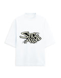 White oversized terry tee with bold 'Still Alive' graffiti-style typography chest print