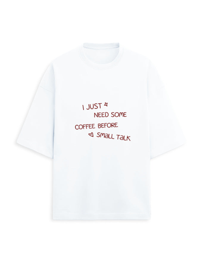 White oversized terry tee with 'I just need some coffee before small talk' handwritten chest print