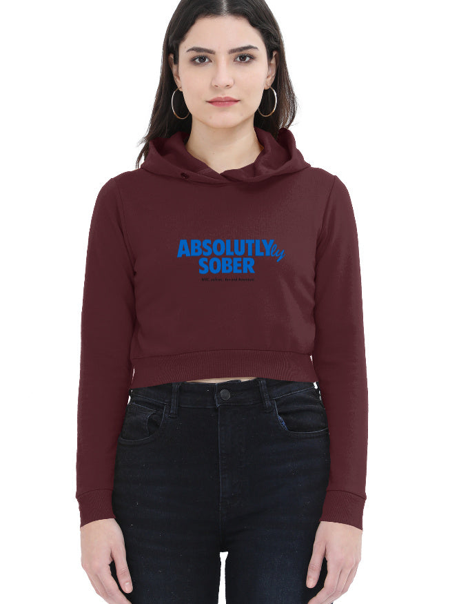 Close-up front view of black cropped hoodie for women with bold blue 'Absolutly Sober' pun typography graphic