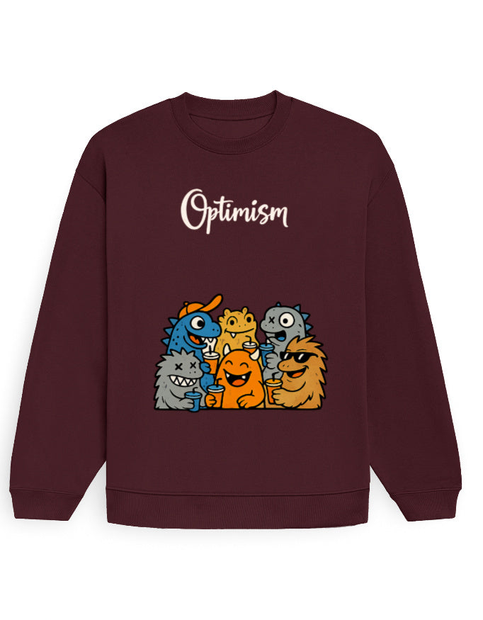 Model wearing the Black oversized sweatshirt with the 'Optimism' cartoon monster graphic on the front