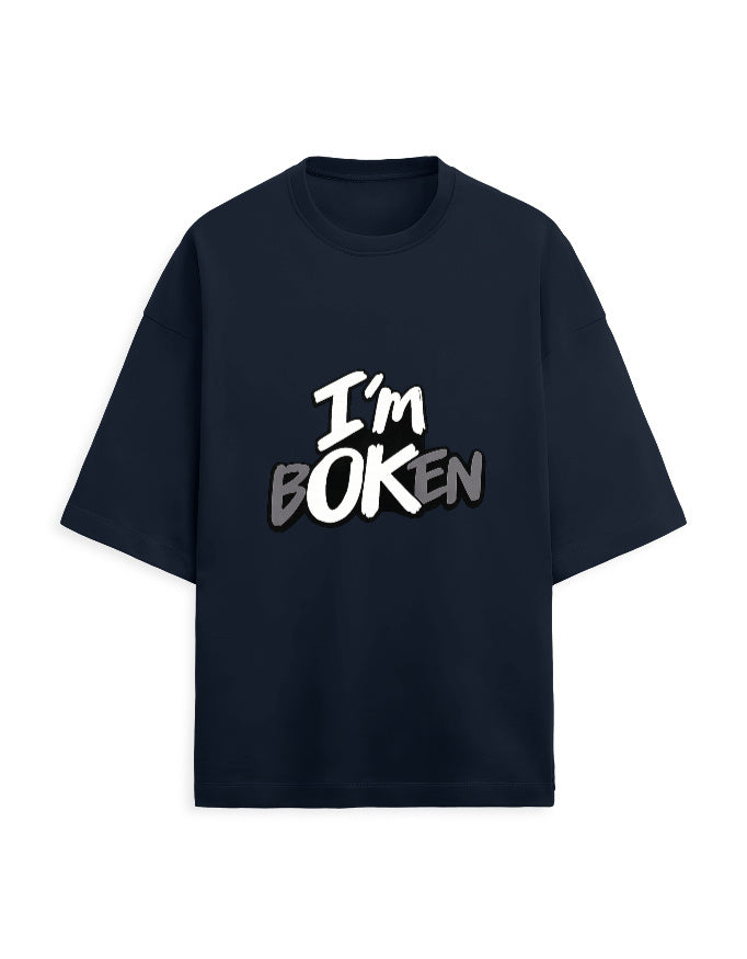 White oversized terry tee on model, front angle with "I'm bOKEN" chest print