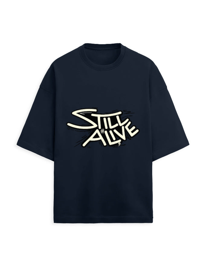 Navy blue oversized terry tee with bold 'Still Alive' graffiti-style typography chest print