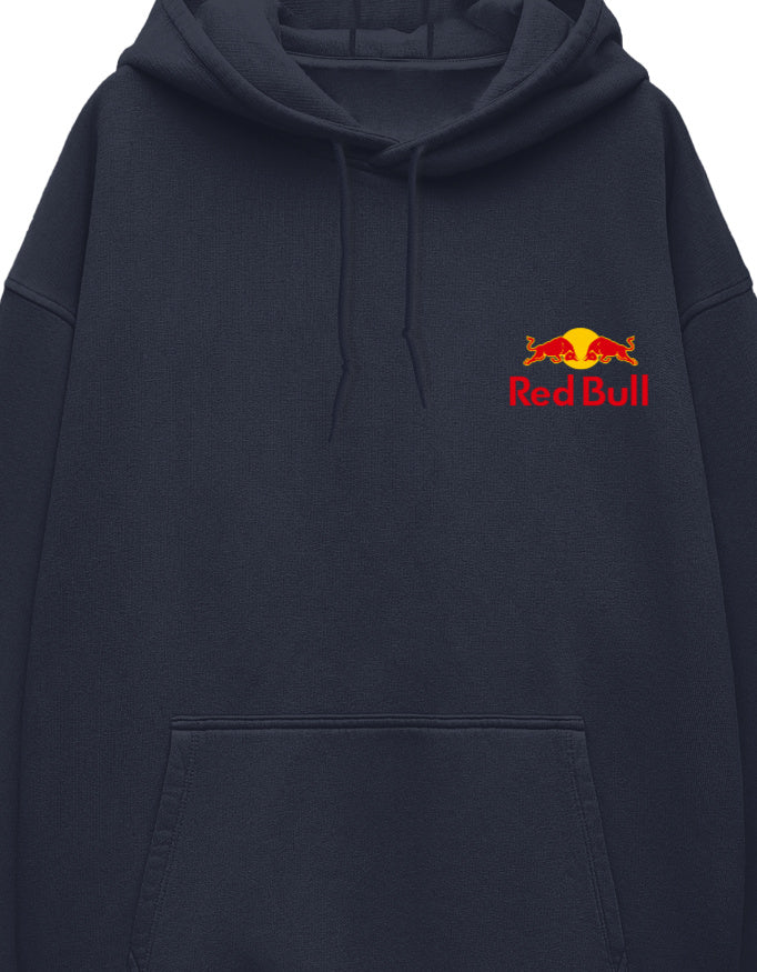 A small red-and-yellow bull emblem and wordmark logo printed on the left chest of a white unisex oversized hoodie.